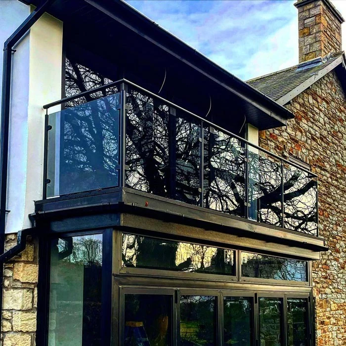 glass-balcony-black-juliet-balcony-stone-house-swansea-swansea-glass-balustrades Glass balcony balustrade showing black juliet balcony stone house in Swansea by Swansea Glass Balustrades